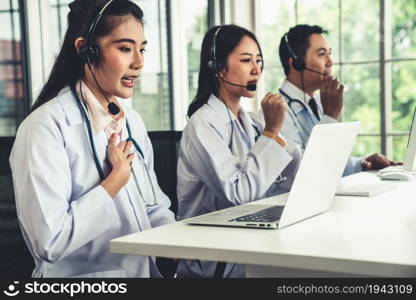 Doctor team wearing headset talking actively on video call in hospital clinic . Concept of telehealth and telemedicine service .. Doctor team wearing headset talking actively on video call in hospital clinic