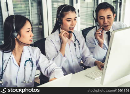 Doctor team wearing headset talking actively on video call in hospital clinic . Concept of telehealth and telemedicine service .. Doctor team wearing headset talking actively on video call in hospital clinic