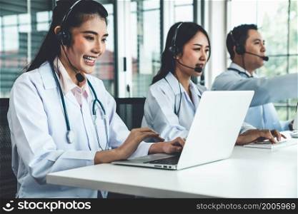 Doctor team wearing headset talking actively on video call in hospital clinic . Concept of telehealth and telemedicine service .. Doctor team wearing headset talking actively on video call in hospital clinic
