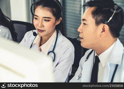 Doctor team wearing headset talking actively on video call in hospital clinic . Concept of telehealth and telemedicine service .. Doctor team wearing headset talking actively on video call in hospital clinic