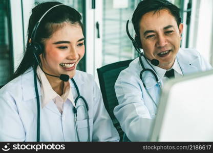 Doctor team wearing headset talking actively on video call in hospital clinic . Concept of telehealth and telemedicine service .. Doctor team wearing headset talking actively on video call in hospital clinic