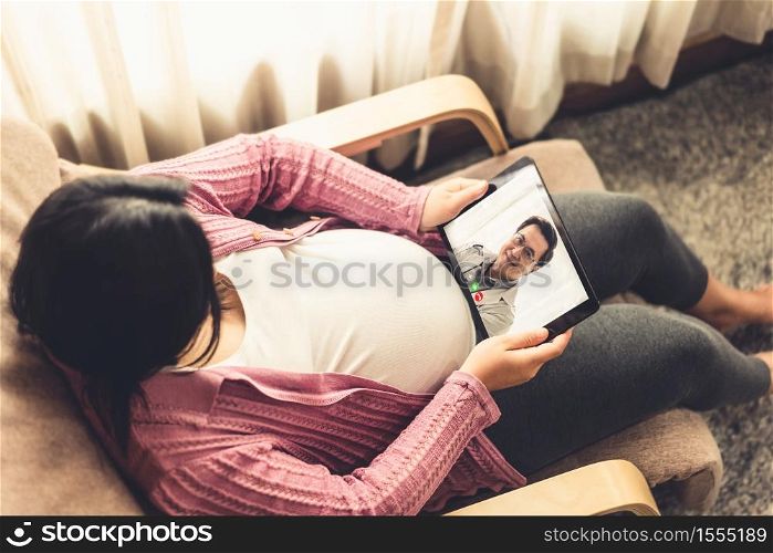 Doctor telemedicine service online video with pregnant woman for prenatal care . Remote doctor healthcare consultant from home using online mobile device connect to internet for live video call .