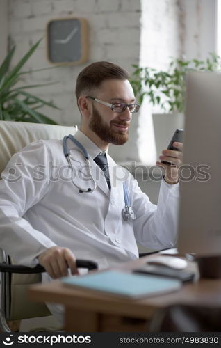 Doctor texting on his smartphone