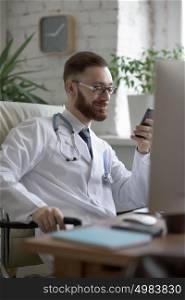 Doctor texting on his smartphone