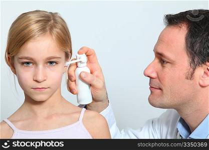 Doctor treating little girl ear infection
