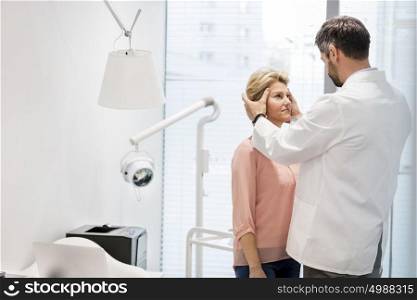 Doctor treating mature patient at hospital