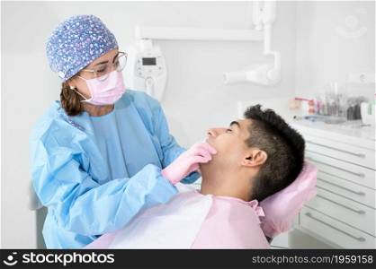 Doctor treats patient teeth in modern dental clinic. High quality photo. Doctor treats patient teeth in modern dental clinic