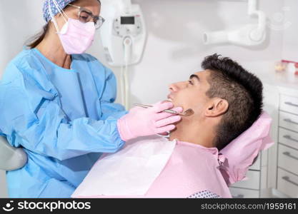 Doctor treats patient teeth in modern dental clinic. High quality photo. Doctor treats patient teeth in modern dental clinic