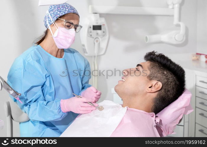 Doctor treats patient teeth in modern dental clinic. High quality photo. Doctor treats patient teeth in modern dental clinic