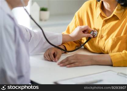 Doctor using a stethoscope checking patient stethoscope putting beat heart diagnose medical checkup cardiologist in examination room