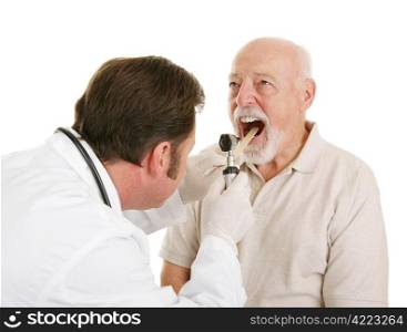 Doctor using a tongue depressor and an otoscope to look inside a senior patient&rsquo;s mouth. Isolated on white.