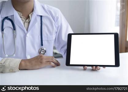 Doctor using computer tablet discussion something with patient. Health care , Hospital and Doctor concept. Copy space of blank computer and tablet screen.