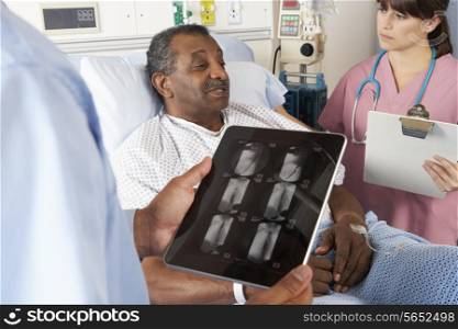 Doctor Using Digital Tablet In Consultation With Senior Patient