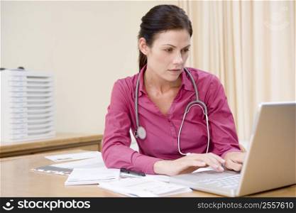 Doctor using laptop in doctor&acute;s office