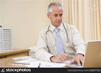 Doctor using laptop in doctor&acute;s office