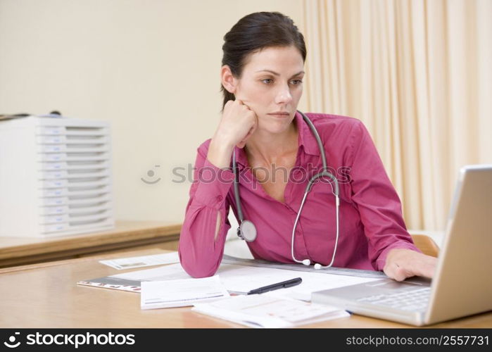 Doctor using laptop in doctor&acute;s office