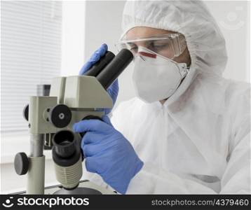 doctor using microscope check covid sample