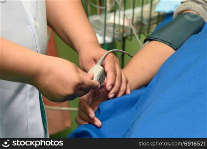 Doctor using pulse oximeter sensor on the patient hand, medical and healthcare concept