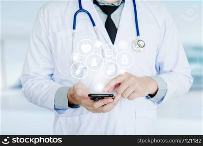 Doctor using smartphone and health care icon on background of Hospital ward