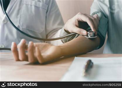 Doctor using stethoscope take a tap on the patient's arm.