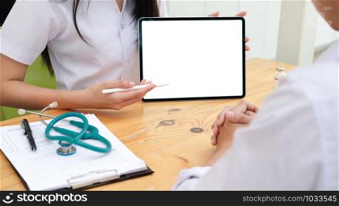 Doctor using tablet discussion something with patient. Health care , Hospital and Doctor concept. Copy space of blank computer and tablet screen.