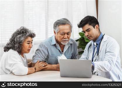 Doctor using technology laptop to explain and talking for auscultate Asian grandparent patient in house, healthcare with Long live and Elderly society, Prevent epidemic, Covid19 Disease concept
