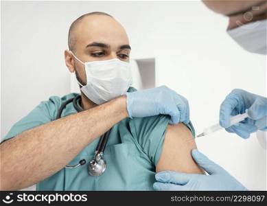 doctor vaccinating patient clinic 2