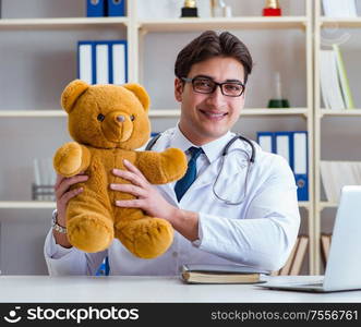 Doctor veterinary pediatrician holding an examination in the office with a teddy bear. Doctor veterinary pediatrician holding an examination in the off