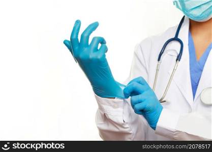 Doctor wearing blue rubber gloves to protect against COVID-19 at the hospital