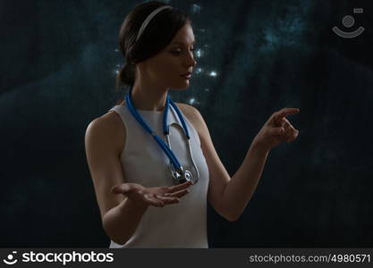Doctor wearing futuristic clothes working with virtual screen. Space background