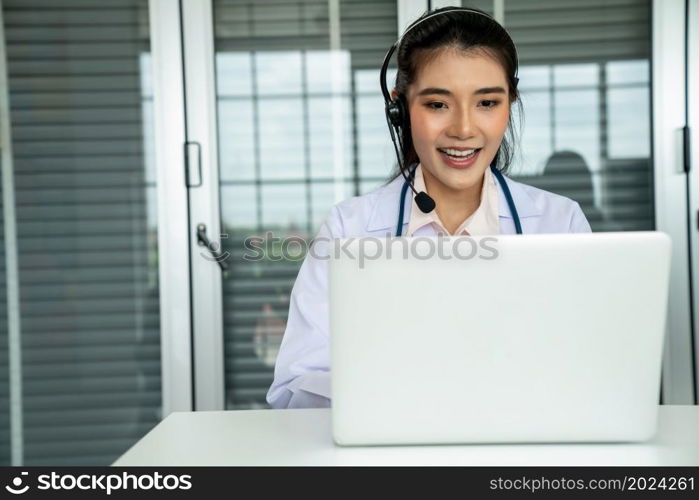 Doctor wearing headset talking actively on video call in hospital or clinic . Concept of telehealth and telemedicine service .. Doctor wearing headset talking actively on video call in hospital or clinic