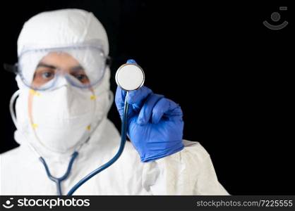 Doctor wearing Protection suit with stethoscope against covid-19 Coronavirus on black background, Concept of Covid-19 quarantine. High quality photo. Doctor wearing Protection suit with stethoscope against covid-19 Coronavirus on black background, Concept of Covid-19 quarantine.