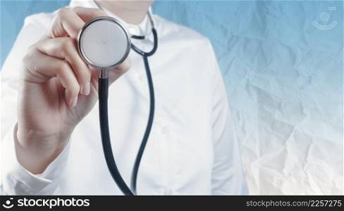 Doctor with a stethoscope in the hand with crumpled paper background