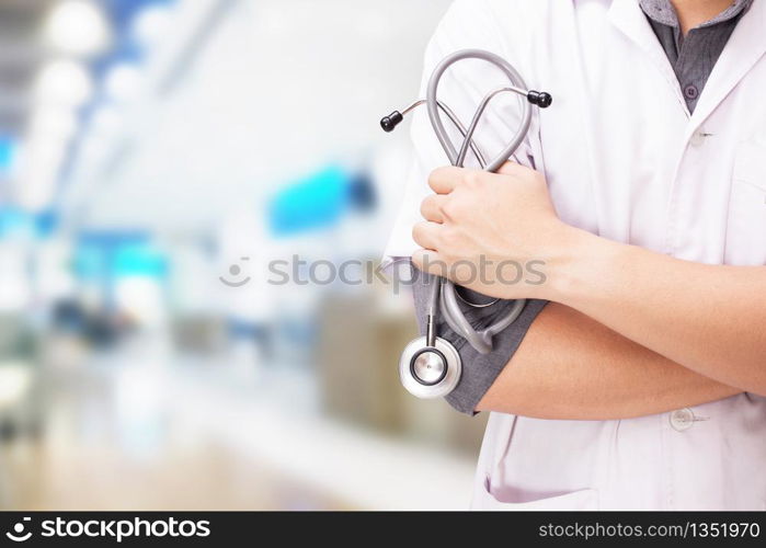 Doctor with a stethoscope in the hands and hospital background.