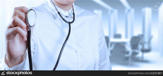 Doctor with a stethoscope in the hands and office background