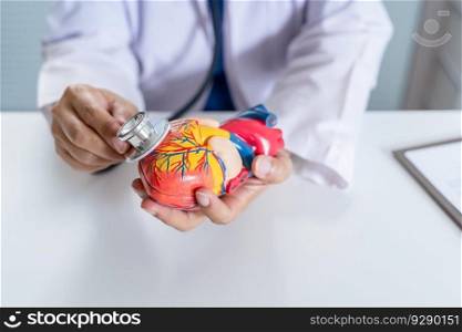 Doctor with anatomical model of human heart Cardiologist supports the heart. heart diagnose medical checkup cardiologist in examination room.