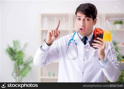 Doctor with bag of blood plasma in hospital