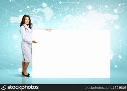 Doctor with banner. Image of young female doctor with blank banner. Place for text