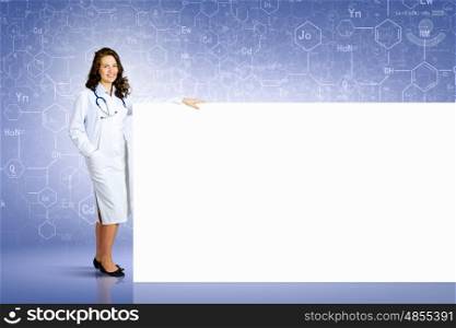 Doctor with banner. Image of young female doctor with blank banner. Place for text
