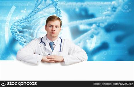 Doctor with banner. Young doctor with white blank banner. Place for text