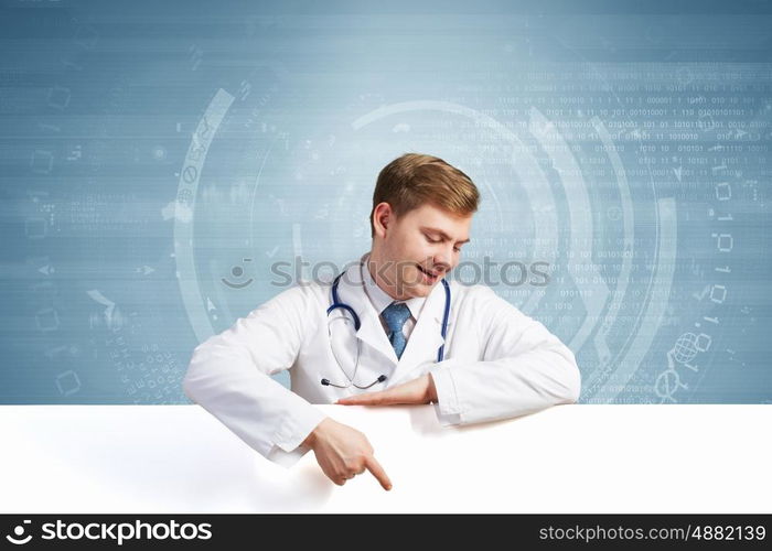 Doctor with banner. Young doctor with white blank banner. Place for text