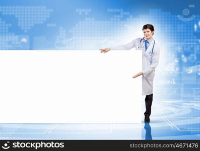 Doctor with blank banner. Young male doctor with blank banner. Place for text