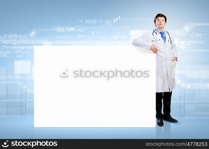 Doctor with blank banner. Young male doctor with blank banner. Place for text