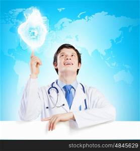 Doctor with blank banner. Young smiling doctor with blank banner. Place for text