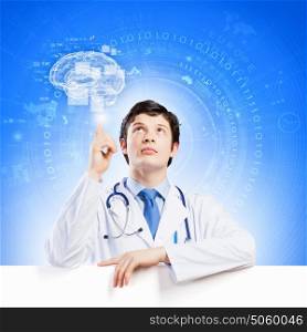 Doctor with blank banner. Young smiling doctor with blank banner. Place for text