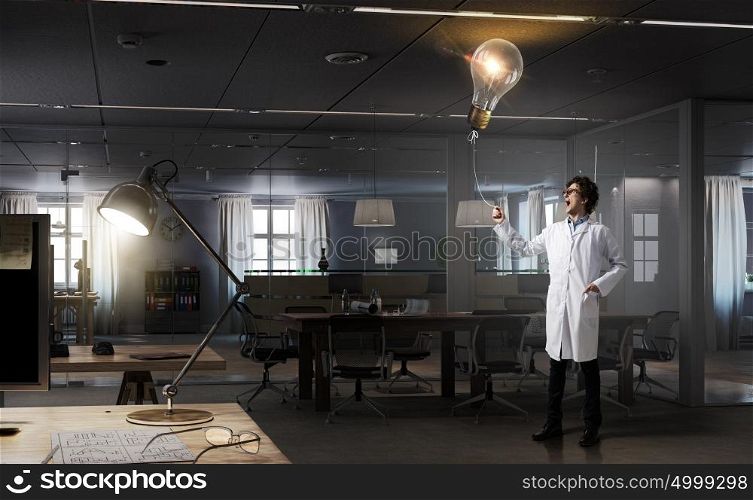 Doctor with bulb balloon. Young doctor in glasses pulling bulb balloon on rope