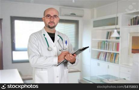 Doctor with clipboard and paperwork in his office at the hospital