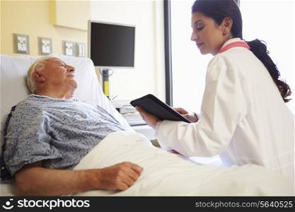 Doctor With Digital Tablet Talking To Patient In Hospital