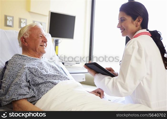 Doctor With Digital Tablet Talking To Patient In Hospital