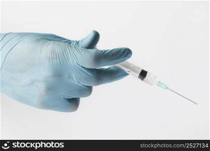 doctor with gloves holding syringe